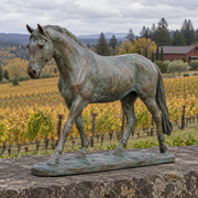 Bracken Walk verdigris bronze walking horse sculpture in a naturally lit outdoor setting.
