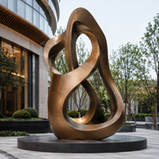 Continuum large bronze abstract loop sculpture displayed in a modern outdoor public space