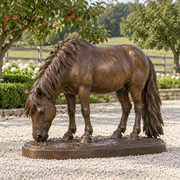 Copper Graze, warm bronze grazing pony sculpture, featured installation view