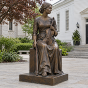 Craft of Memory bronze seated violinist sculpture photographed in natural light.