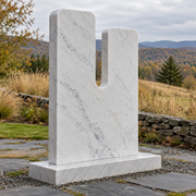 Daybreak Cleft white marble minimalist notched memorial sculpture photographed in natural light.