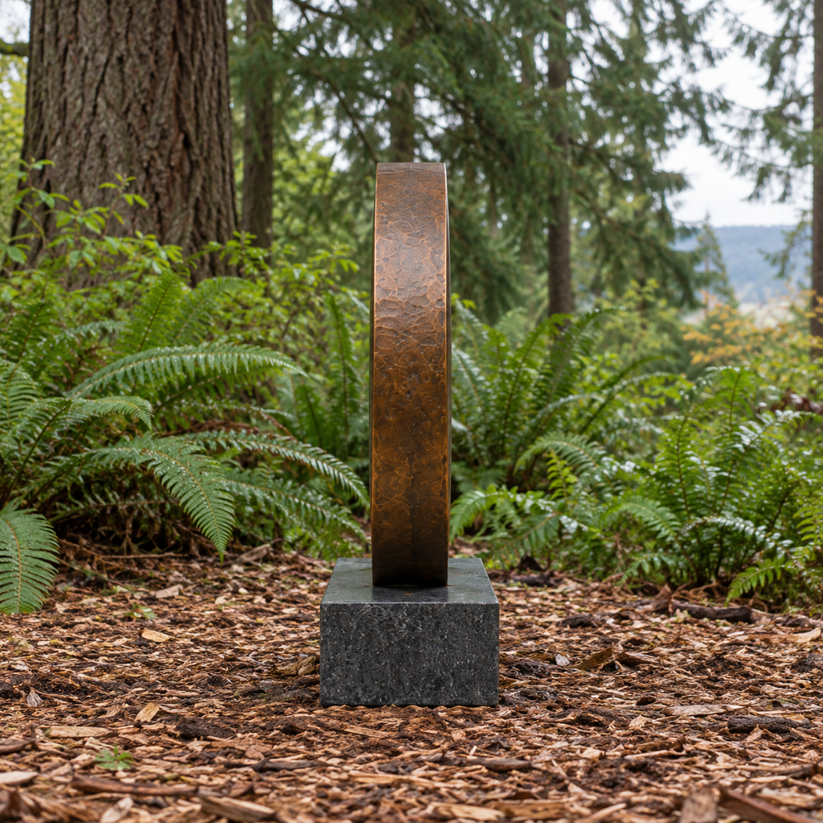 Side view of Earthbound Echo bronze minimalist split disc memorial sculpture in a garden setting.