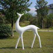 Elegant Spirit white fiberglass deer sculpture displayed in a modern outdoor garden setting