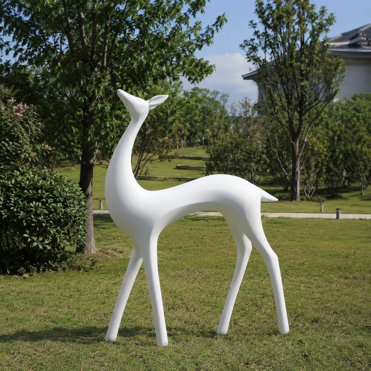 Elegant Spirit white fiberglass deer sculpture displayed in a modern outdoor garden setting