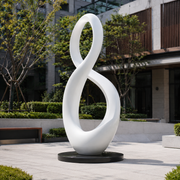 Endless Harmony white fiberglass infinity sculpture displayed in a contemporary outdoor setting