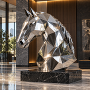 Faceted Stallion mirror stainless steel geometric horse bust sculpture displayed on a black stone pedestal in a luxury contemporary lobby.