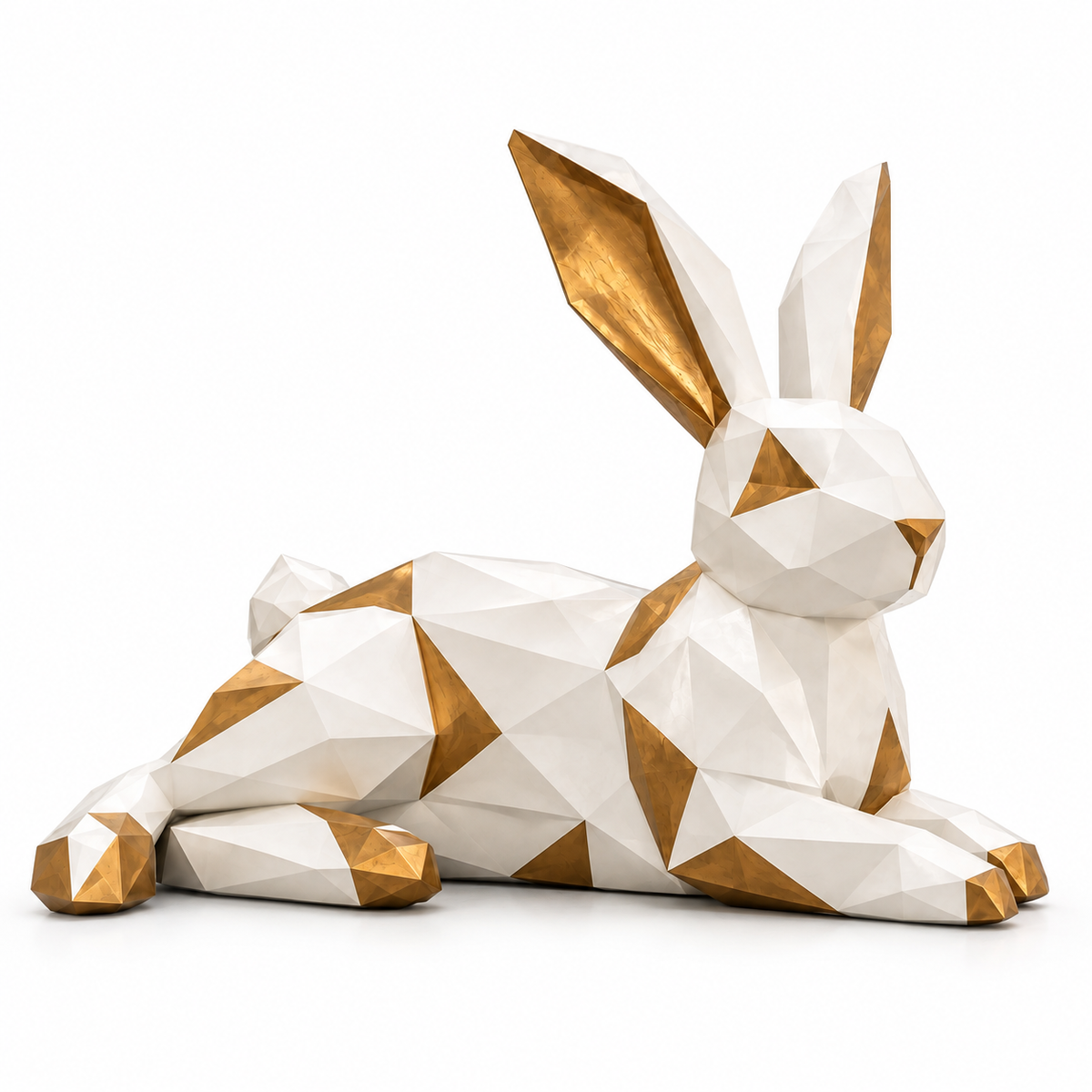 White and gold fiberglass geometric reclining rabbit sculpture with faceted surfaces on a white background