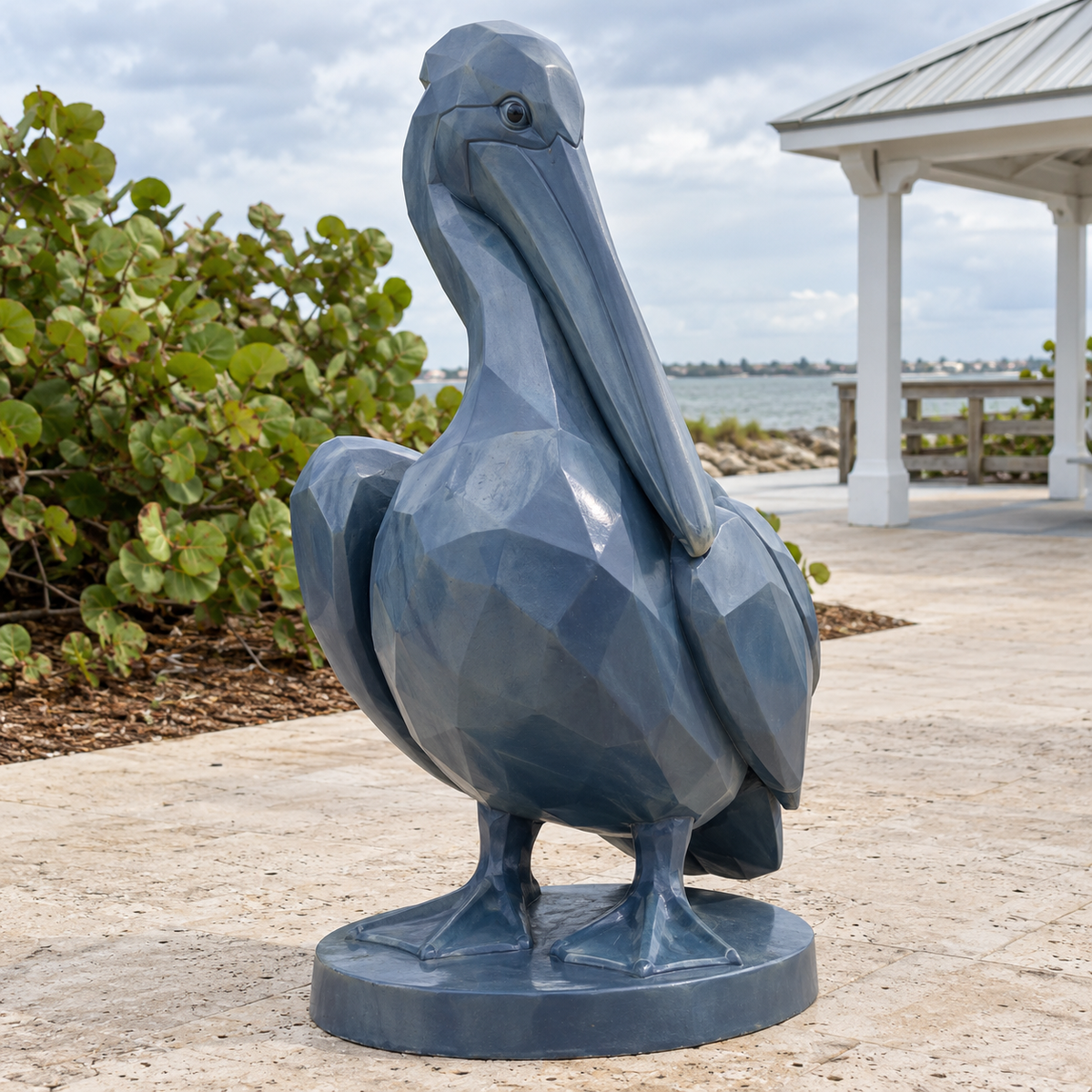 Harbor Patience slate blue fiberglass geometric pelican sculpture photographed in natural light.