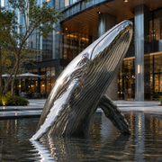 Ocean Ascend large mirror stainless steel breaching whale sculpture displayed in a modern commercial public space with a reflecting pool.