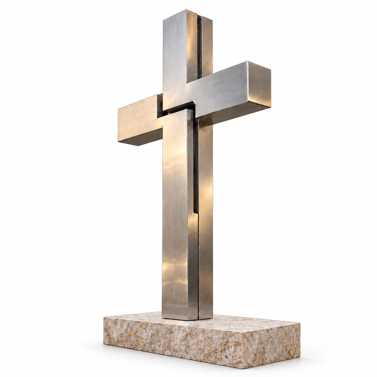 Brushed stainless steel geometric Christian cross sculpture on a natural stone base against a white background