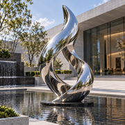 Silver Flame mirror stainless steel abstract sculpture displayed in a modern commercial plaza with a reflecting pool and contemporary architecture.