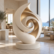 Spiral Reverie warm white and champagne gold fiberglass abstract spiral sculpture displayed in a luxury coastal interior